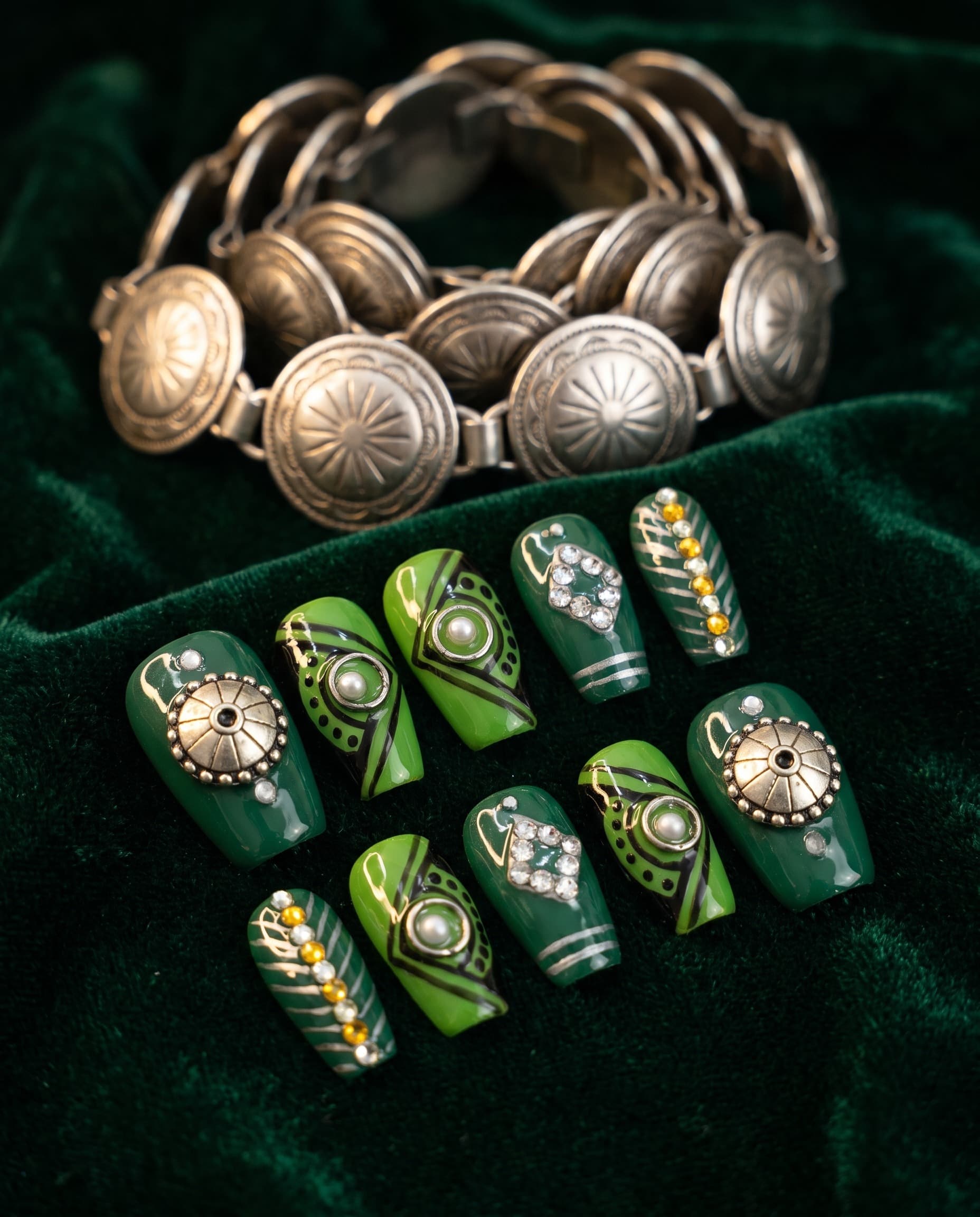 Emerald Concho — Dark emerald and green with silver coin-medallion studs, diagonal stripes, and rhinestone diamonds