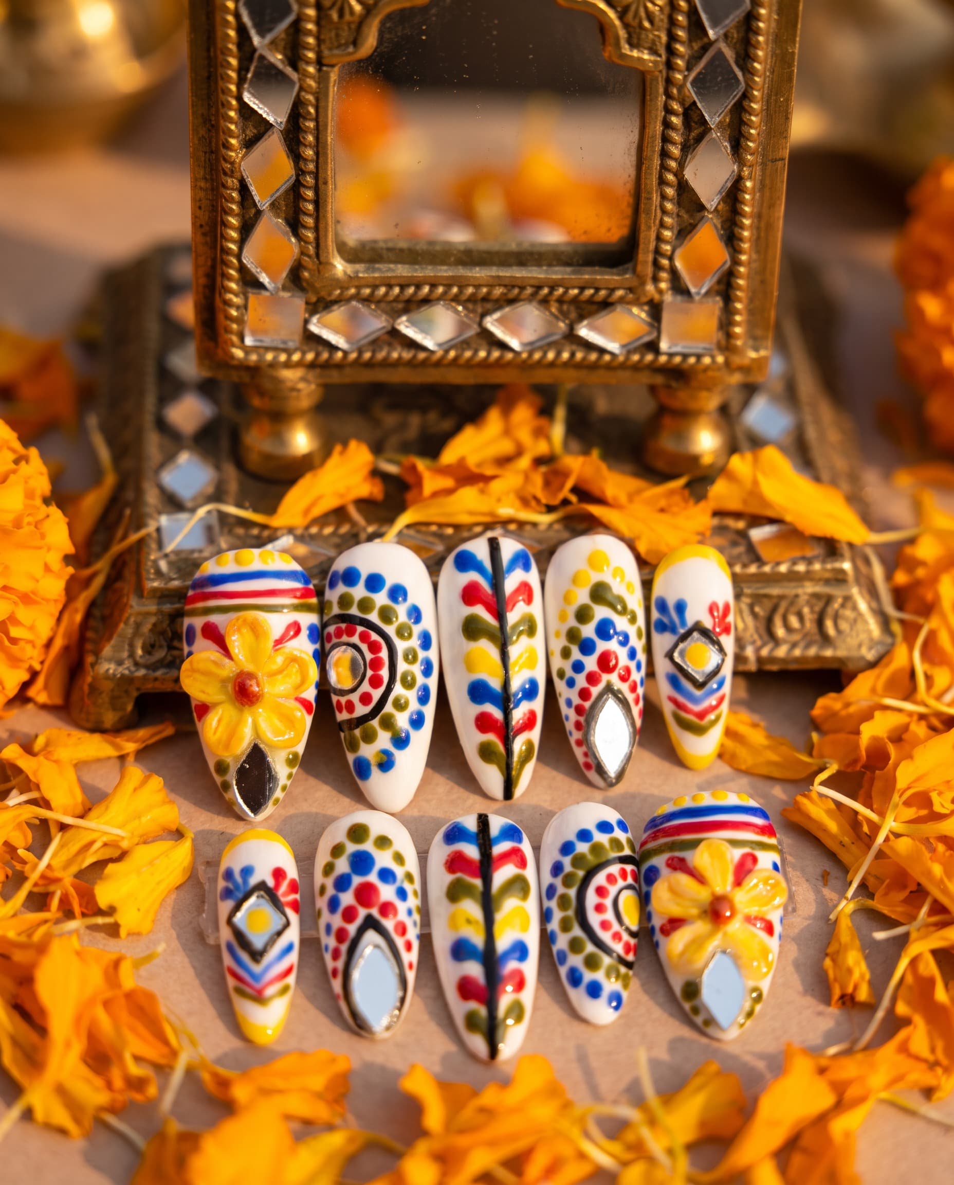 Rangoli Folk — White base with a colorful hand-painted folk pattern, mirror inlays, and a 3D yellow flower