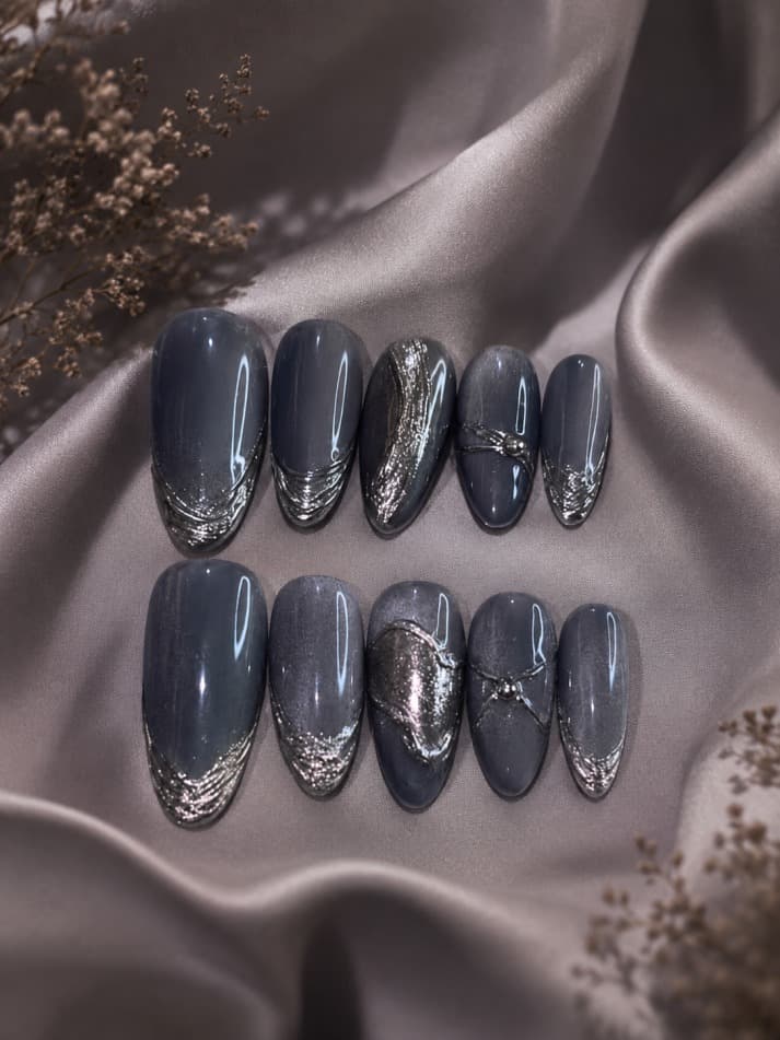 Midnight Ball — Slate-grey cat-eye with a metallic silver crackled-foil texture and one spider-web accent nail