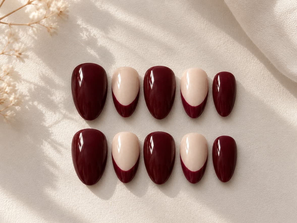 Mulberry French — Deep wine-maroon nails alternating with a nude reverse French tip