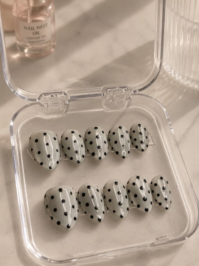 Polkas & Cateye — Shimmering pearlescent grey-white cat-eye base with hand-painted black polka dots